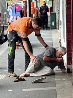 Bread Street bakery owner David Winter is assisted by a Good Samaritan after he was allegedly headbutted. Picture: supplied