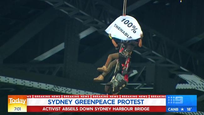 The protester unfurled a banner that read “100% renewables”. Picture: 9News