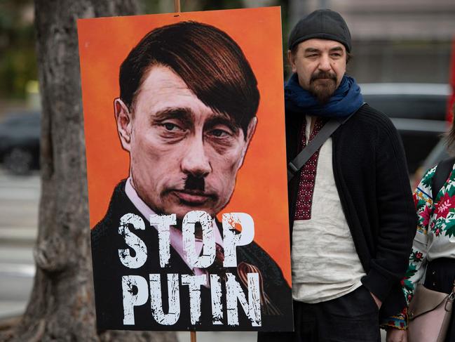 A demonstrator holds a sign depicting the Russian president as Adolf Hitler in Barcelona during a protest against the invasion of Ukraine – an indication that Moscow’s propaganda about the operation has not been widely believed. Picture: AFP