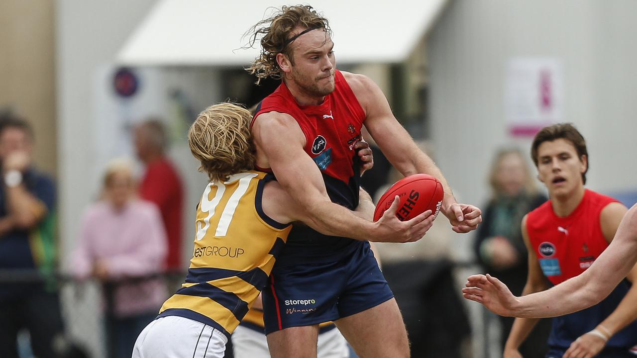 VAFA: Jack Watts of Old Brighton gets wrapped up by Old Melburnians’ Sam Cameron. Picture: Valeriu Campan