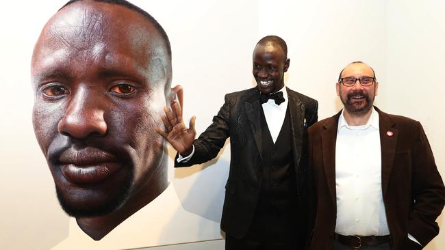 Deng Adut and Nick Stathopoulos with the portrait.