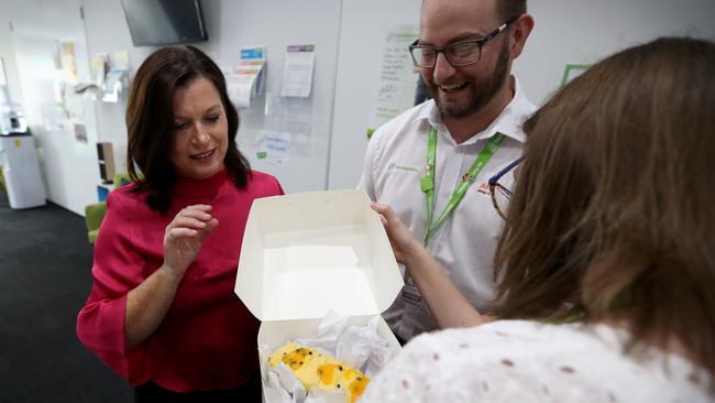 Jen Morrison hands over a cake for morning tea at headspace. Picture: Jamie Hanson