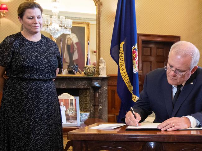 Australian Prime Minister Scott Morrison photographed signing a book of condolence at Government Hour in Sydney to pay his respects to HRH Prince Philip, The Duke of Edinburgh, who died in the UK last night (Australia time). To the left of the picture is his wife Jenny and the the right is Governor-general David Hurley and his wife Linda(Pictures by Julian Andrews).