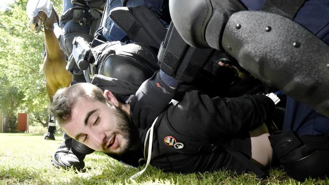 A protester is arrested in Melton. Picture: Jason Edwards