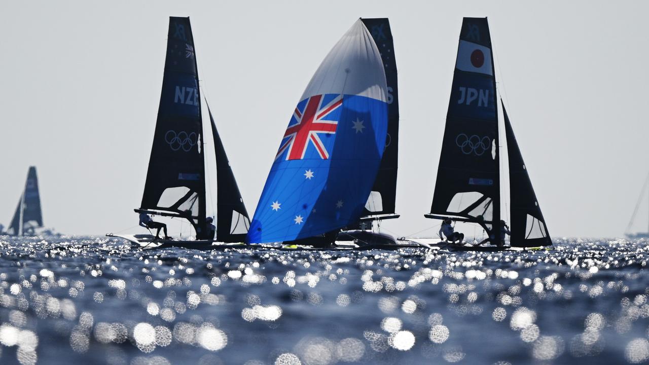 Jo Aleh and Molly Meech of Team New Zealand, Olivia Price and Evie Haseldine of Team Australia and Misaki Tanaka and Sera Nagamatsu of Team Japan compete in the Women's Skiff on day three of the Olympic regatta. Picture: Clive Mason/Getty Images