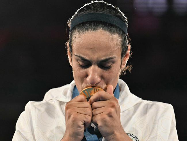 TOPSHOT - Gold medallist Algeria's Imane Khelif poses on the podium during the medal ceremony for the women's 66kg final boxing category during the Paris 2024 Olympic Games at the Roland-Garros Stadium, in Paris on August 9, 2024. (Photo by MOHD RASFAN / AFP)