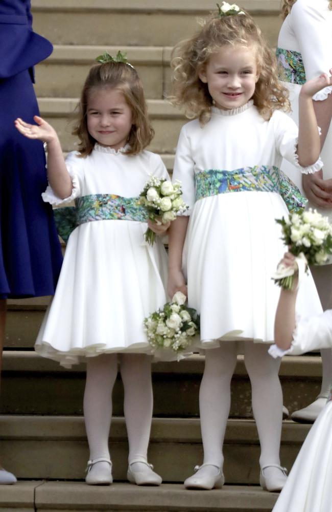 Princess Charlotte waves to Princess Eugenie and her new husband Jack Brooksbank after their wedding ceremony at St Georgeâ€™s Chapel, Windsor Castle, near London, England, Friday Oct. 12, 2018. (Andrew Matthews, Pool via AP)