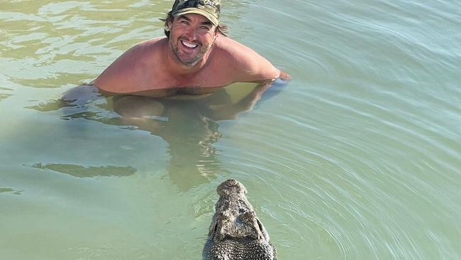 Crocodile Wrangler Matt Wright jumped in the waters by his Tiwi Island Retreat  last week to swim with resident croc Claudia. Picture: Matt Wright