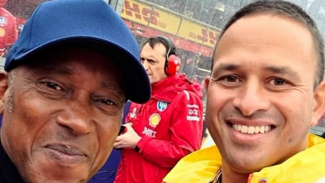 Usman Khawaja (right) with Lewis Hamilton's dad Anthony.