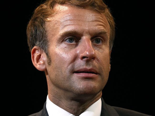 French President Emmanuel Macron looks on as he attends a reading of Marcel Proust's books in Illiers-Combray, west of Paris, on September 15, 2021 as part of the European Heritage days. - French writer Marcel Proust spent part of his childhood in this house and was inspired by it for his book 'A la recherche du temps perdu' (In Search of Lost Time). (Photo by Yoan VALAT / POOL / AFP)