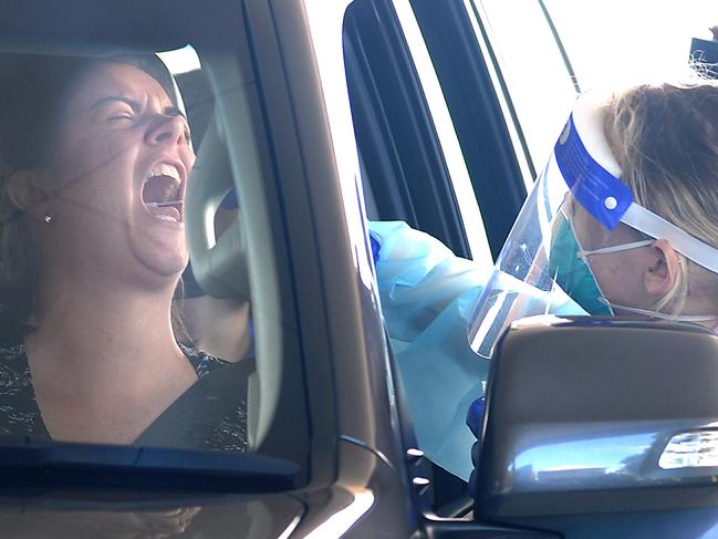 A woman receives a COVID-19 test at a drive-through clinic in Brisbane's Bowen Hills yesterday. Picture: John Gass