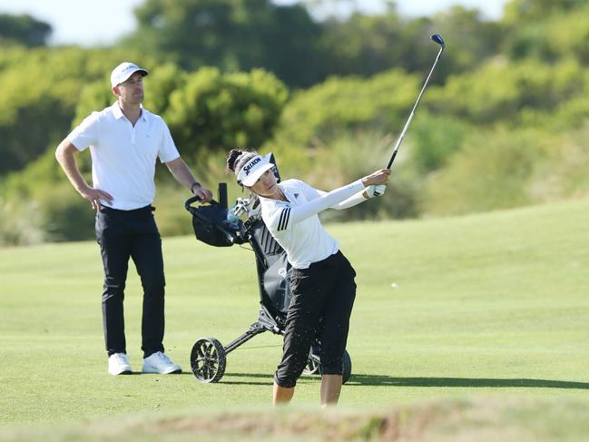 Geelong Cats legend Joel Selwood learning from golf pro Grace Kim at 13th Beach Golf Links. Picture: Alan Barber