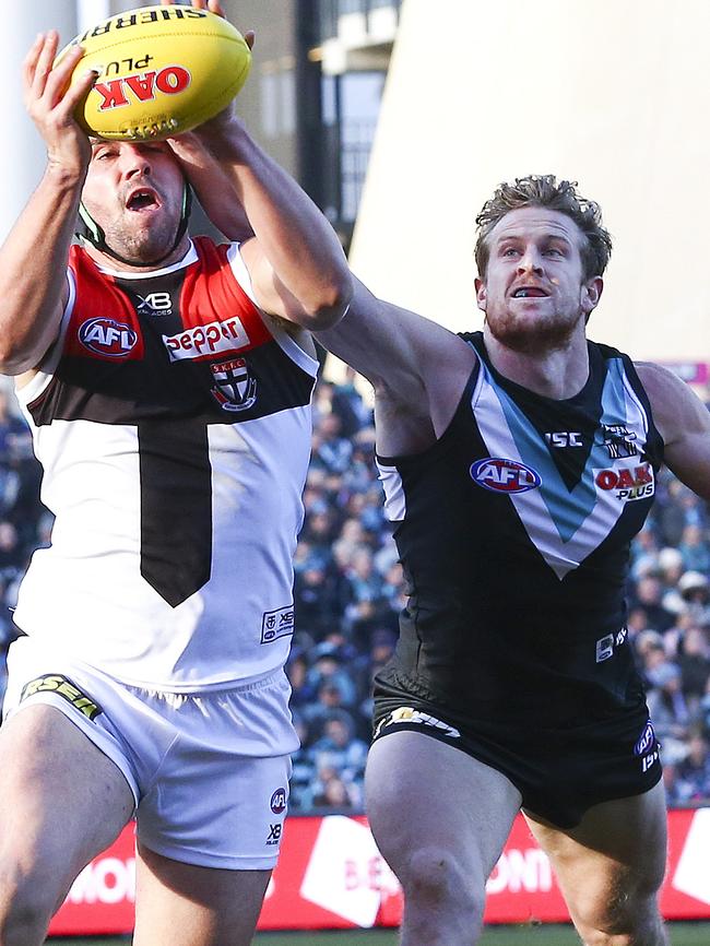 Tom Jonas punches the ball away from Saint Paddy McCartin. Picture: Sarah Reed