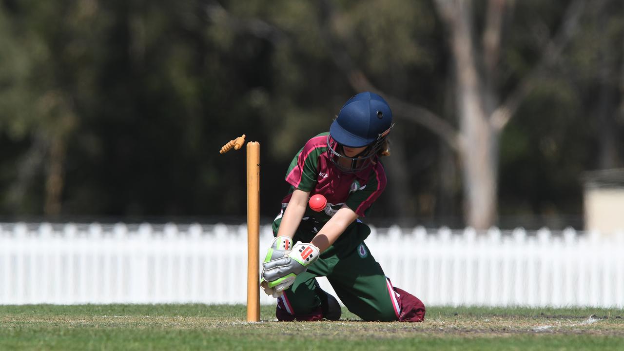 Souths keeper Eve Mollee attempts a run out in a game against the Sunshine Coast