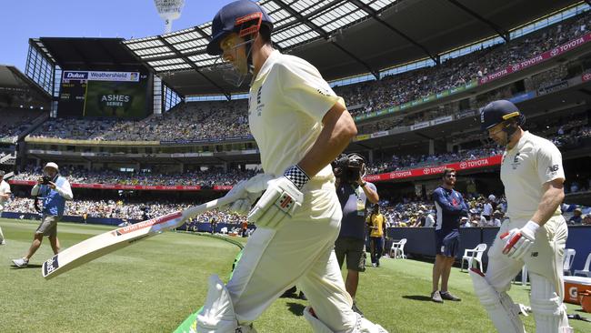 England's Alastair Cook, left, and Mark Stoneman run out to bat against Australia. Picture: AP.