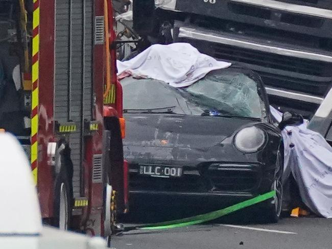 The Porsche 911 trapped under the truck on the Eastern Freeway.