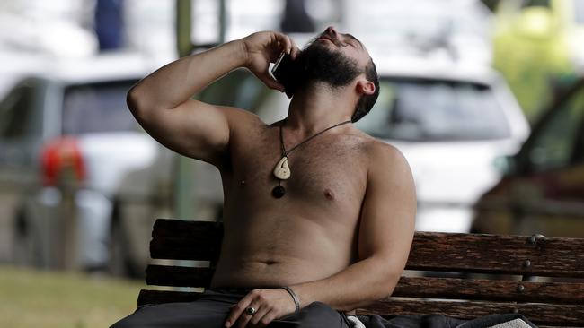 A man reacts as he speaks on a mobile phone outside a mosque in central Christchurch. Picture: AP