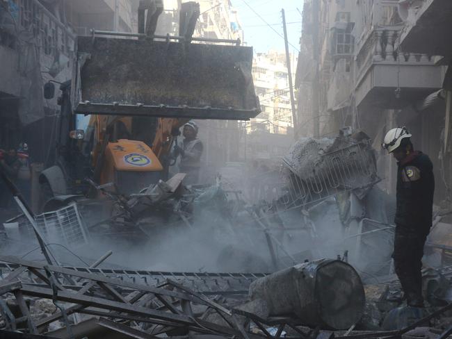 Syrian rescuers search for survivors from under the rubble following a reported air strike on the rebel-held neighbourhood of al-Kalasa in the northern Syrian city of Aleppo, on February 4, 2016. Picture: AFP/Thaer Mohammed