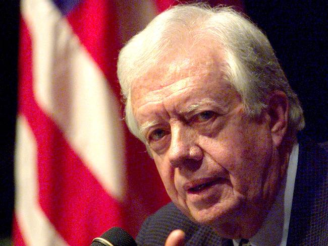 (FILES) Former US president Jimmy Carter gestures while addressing a press conference April 1, 1999 during his visit to the Indonesian capital. Carter, the 100-year-old former US president and Nobel peace laureate who rose from humble beginnings in rural Georgia to lead the nation from 1977 to 1981, has died, his nonprofit foundation said on December 29, 2024. (Photo by Emmanuel DUNAND / AFP)