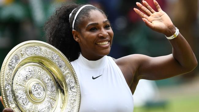 (FILES) In this file photo taken on July 09, 2016 US player Serena Williams poses with the winner's trophy, the Venus Rosewater Dish, after her women's singles final victory over Germany's Angelique Kerber on the thirteenth day of the 2016 Wimbledon Championships at The All England Lawn Tennis Club in Wimbledon, southwest London. Serena Williams will start her bid for an eighth Wimbledon title next week at the 2018 Wimbledon Championships. / AFP PHOTO / GLYN KIRK / RESTRICTED TO EDITORIAL USE