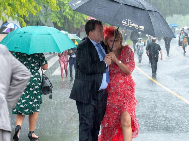 Melbourne Cup day at Flemington.Punters rush in from the station with the rain.Picture Jay Town