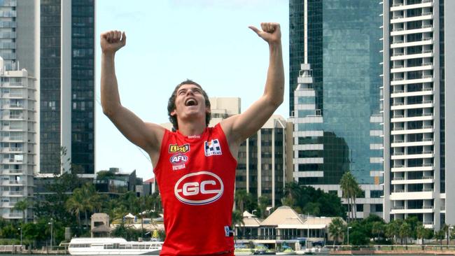 Suns player Marc Lock lets out a yell to let everyone know the Gold Coast has a team in the AFL in 2011.