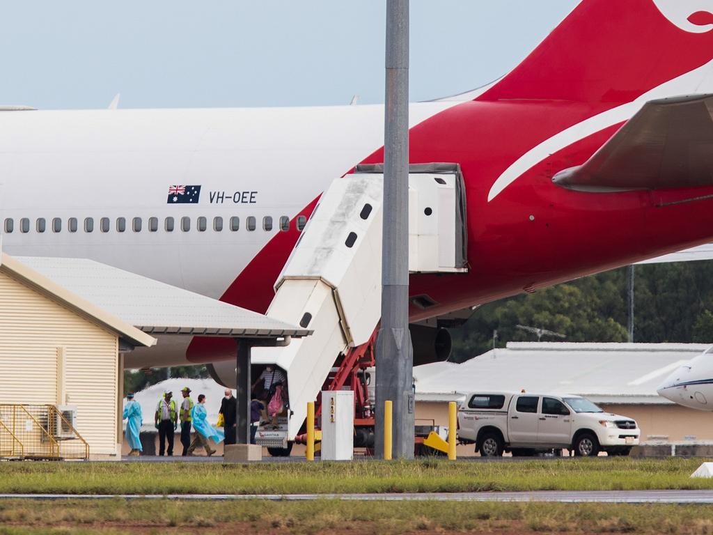 Australian evacuees from the coronavirus-struck cruise ship Diamond Princess deplane a Qantas flight from Japan at Darwin International Airport in Darwin, Thursday, February 20, 2020. Hundreds of Australians evacuated from the Diamond Princess will be quarantined at a workers camp in Howard Springs. (AAP Image/Helen Orr) NO ARCHIVING