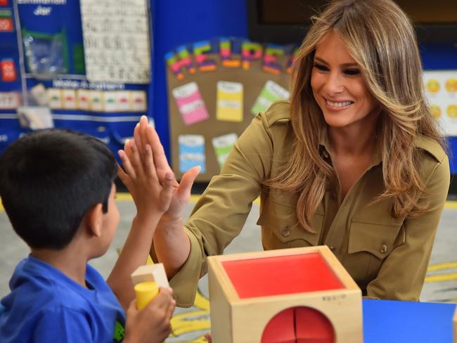 First Lady Melania Trump shares a laugh with a child during a visit to the American International School in the Saudi capital Riyadh on Sunday. Picture: Giuseppe Cacace/AFP