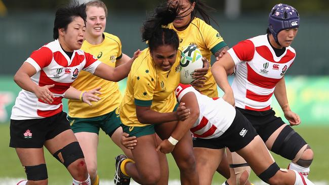 Mahalia Murphy is tackled during the Women's Rugby World Cup Pool C match between Australia and Japan at Billings Park.