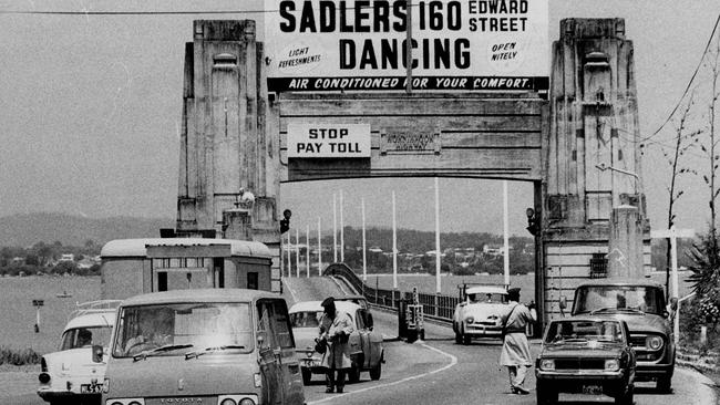 News/buldings/transport 3/11/1969 Hornibrook Highway. Toll being collected on the bridge by toll man in 1969. The Courier-Mail Photo Archive.