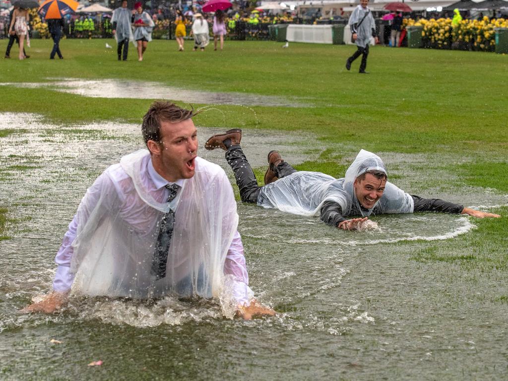 If there’s a hint of rain at the Melbourne Cup, men diving into water is also a common theme. Picture: Jason Edwards