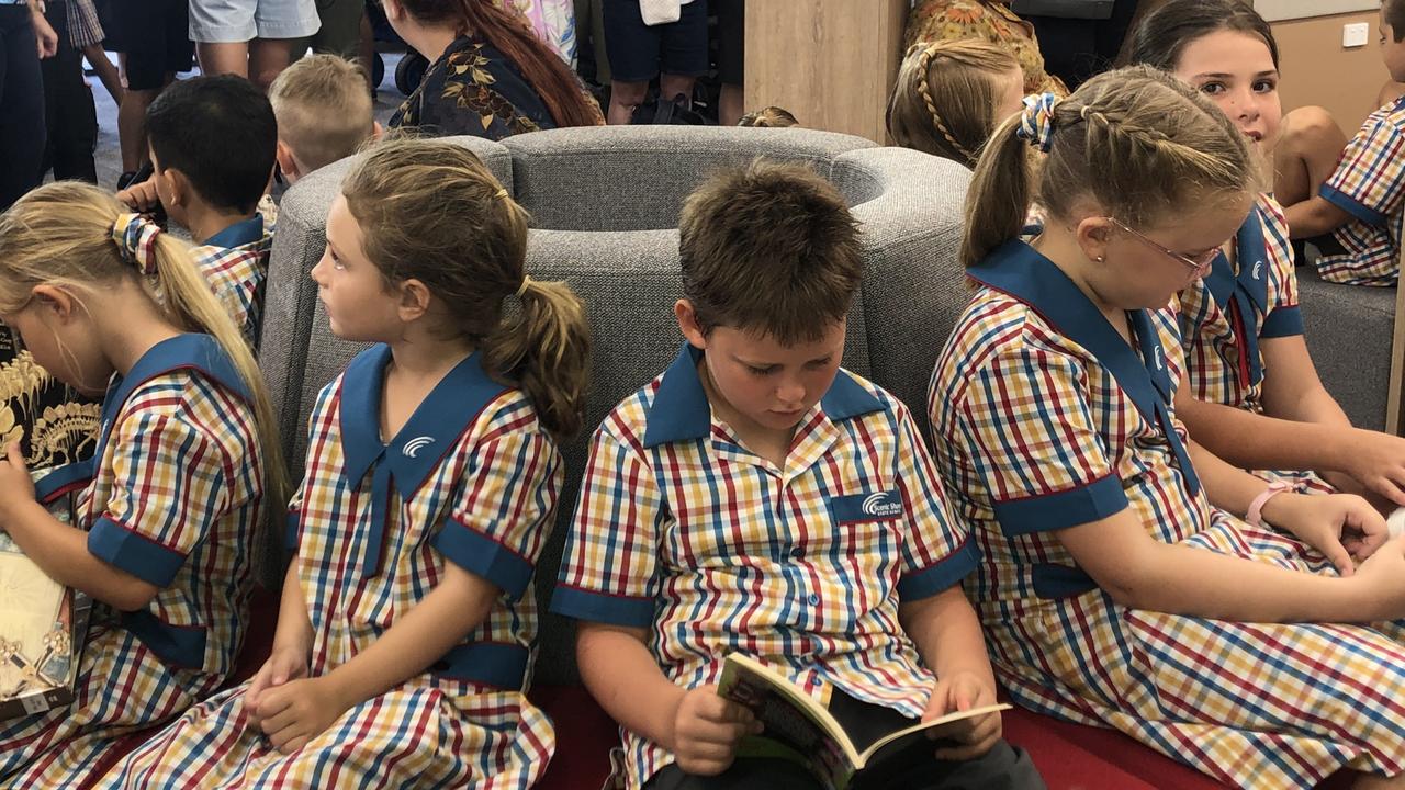 Having fun reading in the airconditioning on the first day of school in prep at Queensland’s newest primary school Scenic Shores State School. Pictures; JUDITH KERR