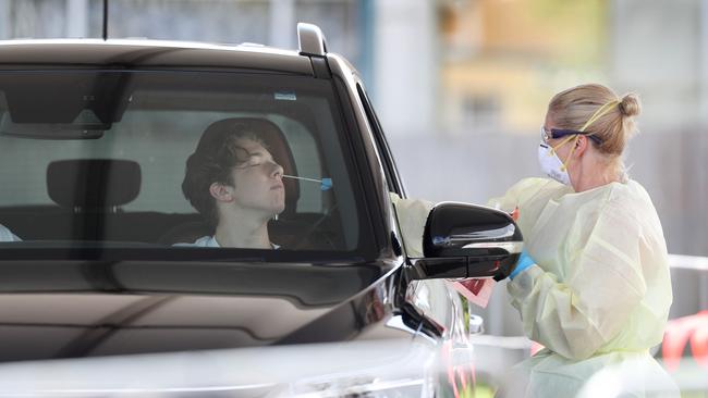 Lynne Barnett testing Dr Chris Lloyd and his son Zachary at the drive-through COVID-19 testing facility. Picture: Sue Graham