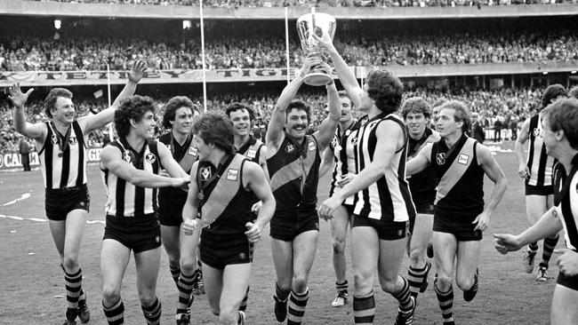 Mick Malthouse carries the 1980 premiership cup.