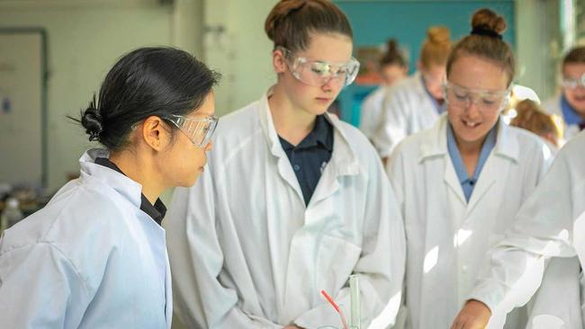 PRACTICAL LESSON: Senex reservoir engineer Mary Kwong with students at the Rockin' Reactions workshop. Picture: KATRINA AYERS