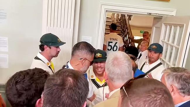 Usman Khawaja and Dave Warner in dispute with several MCC Members in the Long Room at Lords during the lunch break.