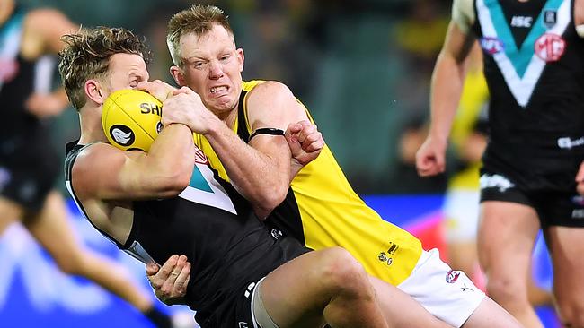 Richmond forward tackles Power opponent Trent McKenzie in Round 111. The Tigers lost the match but Mick McGuane rates them a better premiership chance. Picture: Getty Images