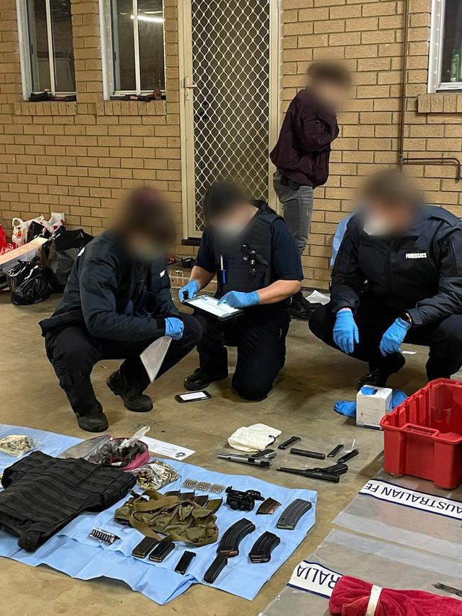 Authorities sort through the seized materials. Picture: AFP