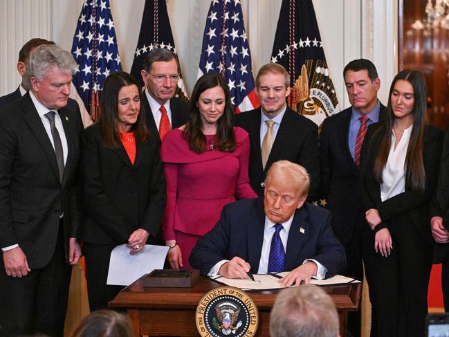 US President Donald Trump signs the Laken Riley Act in the East Room of the White House, while surrounded by the family of the murdered student. Picture: AFP