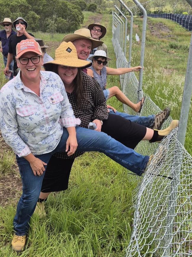 Protesters remove part of the new 1.8m high boundary fence on landowner Michelle Hunt's property.