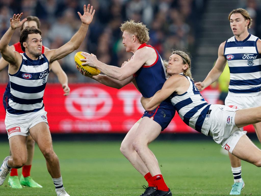 MELBOURNE, AUSTRALIA - MAY 04: Clayton Oliver of the Demons is tackled by Mark Blicavs of the Cats during the 2024 AFL Round 08 match between the Melbourne Demons and the Geelong Cats at The Melbourne Cricket Ground on May 04, 2024 in Melbourne, Australia. (Photo by Dylan Burns/AFL Photos)