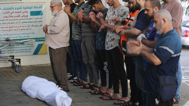 Citizens mourn the body of a Palestinian killed during Israeli air strikes. Picture: Getty Images