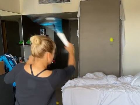 Tennis player Yulia Putintseva hitting her tennis ball in her Melbourne hotel room.