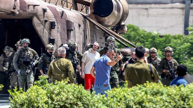 Israeli hostage Andrei Kozlov, 27, disembarks with soldiers from an air force CH-53 Sea Stallion military helicopter after being rescued. Picture: AFP