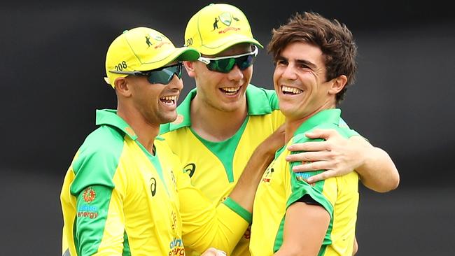 Sean Abbott celebrates with Ashton Agar and Cameron Green during game three of the One Day International series between Australia and India at Manuka Oval. Picture: Getty Images