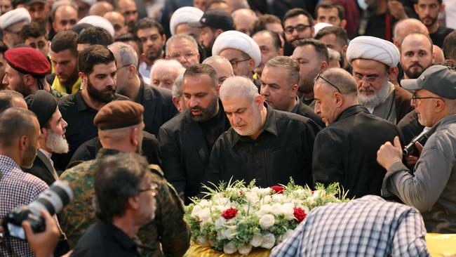 Head of Hezbollah parliamentary block Mohammed Raad, centre, pays his respect at the funeral of Muhammad Neamah Naser in Beirut on Thursday. Picture: AFP