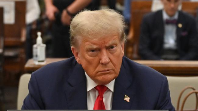 Former US President Donald Trump sits inside the courtroom for the third day of his civil fraud trial in New York on October 4, 2023. The New York judge presiding over Donald Trump's trial for allegedly covering up hush money payments linked to extramarital affairs ordered a delay on March 15, 2024 in proceedings that had been scheduled to get underway on March 25. (Photo by ANGELA WEISS / AFP)