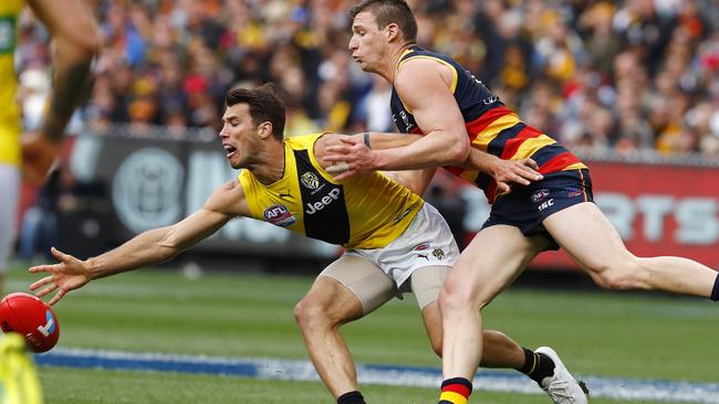 Alex Rance knocks the ball clear of Adelaide's Josh Jenkins. Pic: Michael Klein