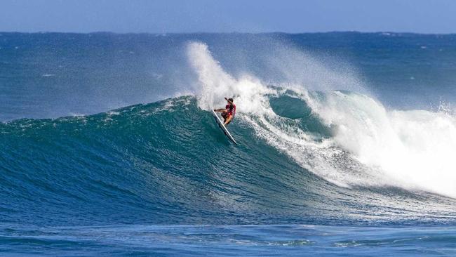 ON A HIGH: The Gold Coast's Jack Freestone has fought his way back onto the WSL World Tour after making the quarter finals of the Vans World Cup at Sunset Beach in Hawaii. Inset: Jack Freestone and his   son, Banks. Picture: Keoki Saguibo