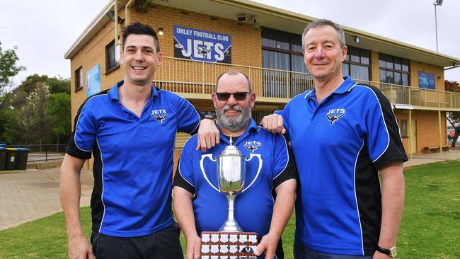 Unley Mercedes senior coach Kane Stewart, operations manager Jeremy Pickering and club president David Heaslip with the Adelaide Footy League club championship trophy. Picture: AAP/Mark Brake